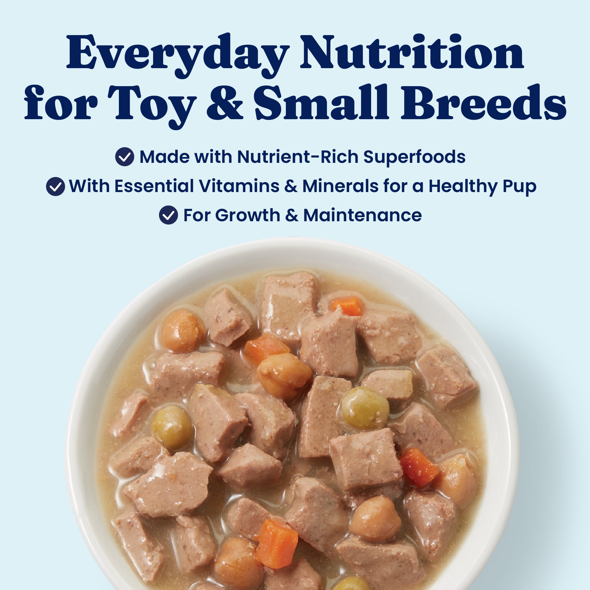 Wet dog food in a bowl featuring small chunks of meat, peas, carrots, and a broth-like sauce.